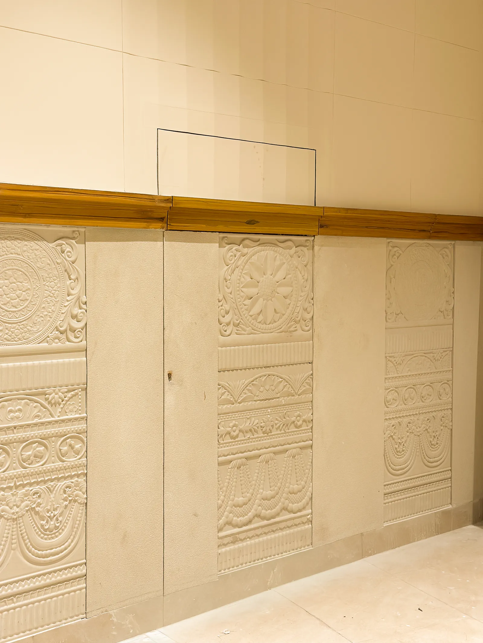 Carved panel wall with timber rail — Chalukya Samrat